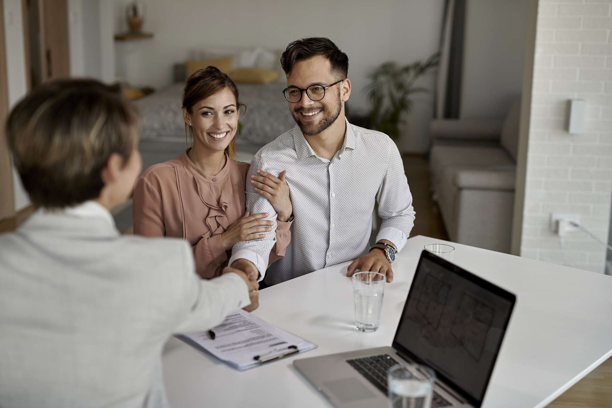 Happy couple meeting with their contractor